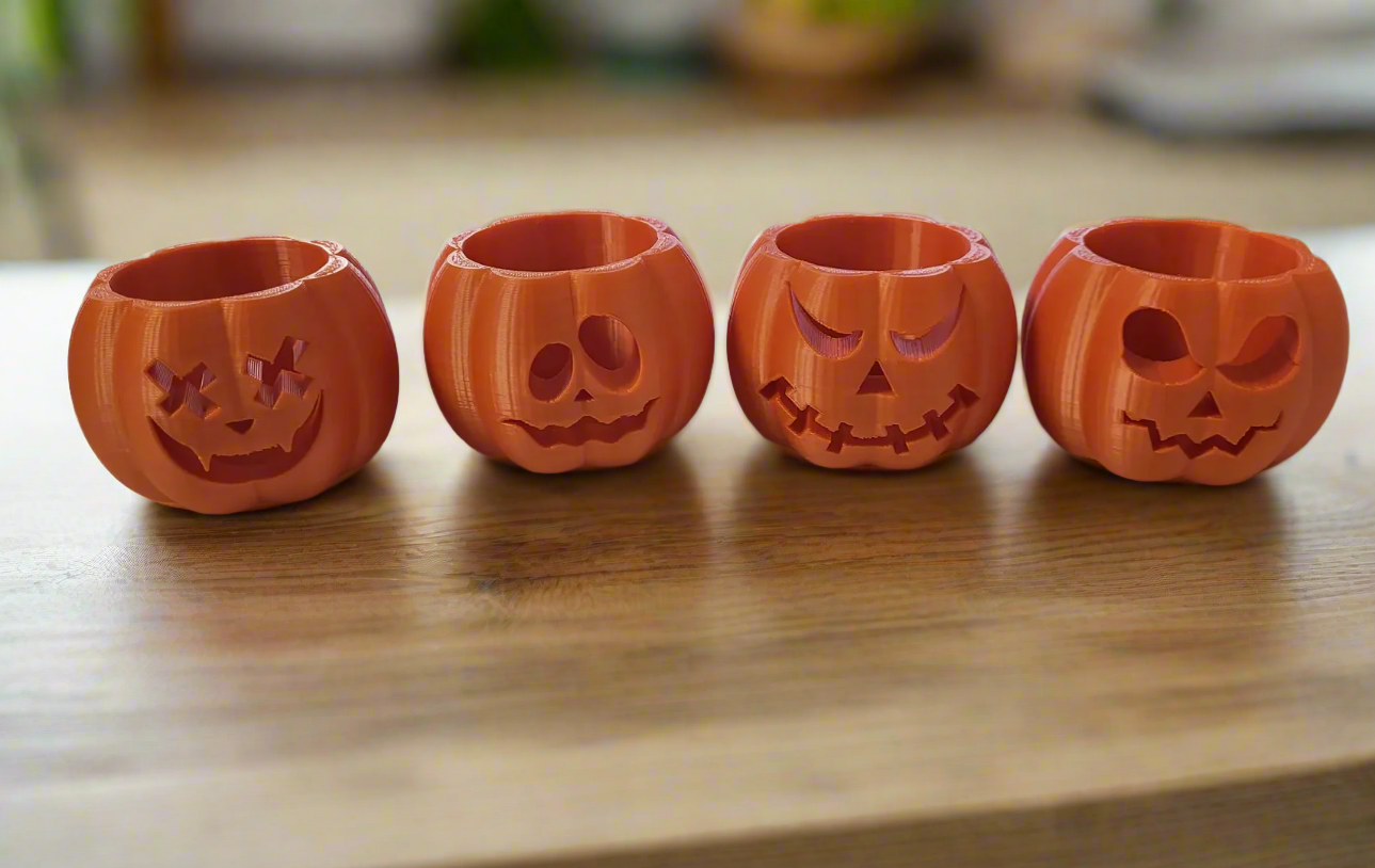 a set of 4 pumpkin shaped halloween tealight holders